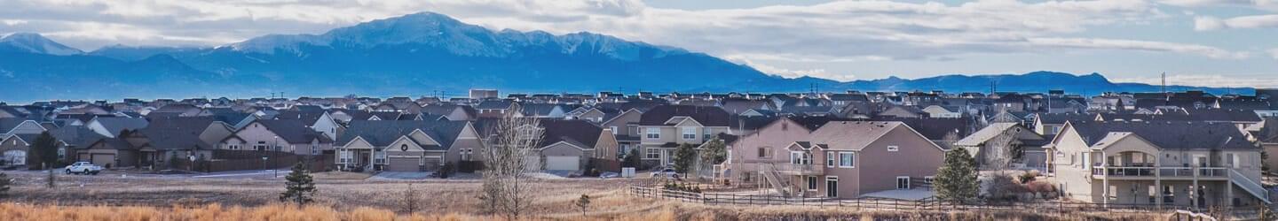 Colorado Springs residential area with mountain range backdrop