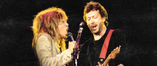 Tina Turner and Eric Clapton singing on stage at Wembley Arena in London in 1987