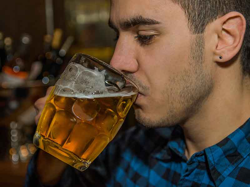 Young student drinking non-aocoholic beer